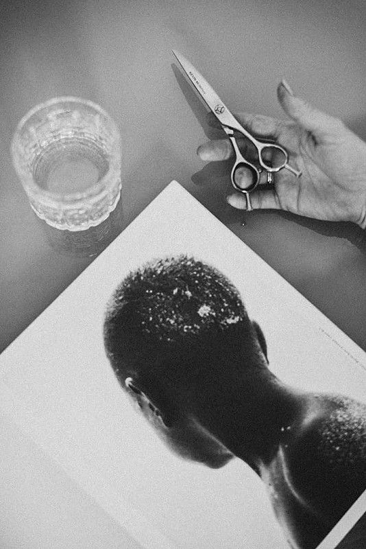 Open magazine on table showing black woman’s hair